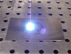 Photo of laser engraving process illustrating how CanLase YAG, CO2 and fiber laser engraving machines are used to engrave or mark almost any material, ranging from metals (stainless steel, aluminum, copper) to plastics.